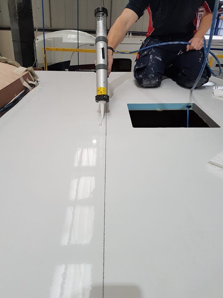 Using glue to bond a panel on a caravan