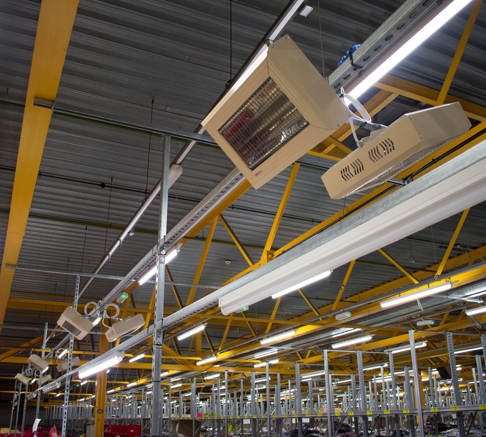 Heaters in a manufacturing facility to speed up adhesive cure time